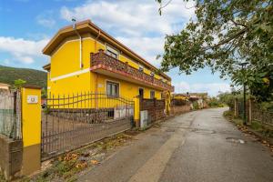 a yellow house on the side of a road at Casa Colonia 2 in SantʼAnna Arresi