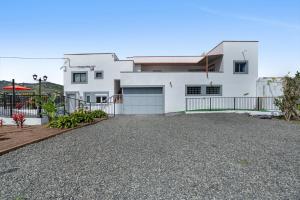 a white house with a driveway in front of it at El Granero in Moya