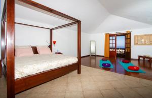 a bedroom with a canopy bed and two mats at Villa Haere Mai in La Asomada +20 photos