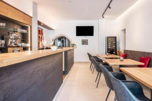 a bar in a restaurant with wooden tables and chairs at Luisl Hof - Apartment Herbae in Cornaiano +20 photos
