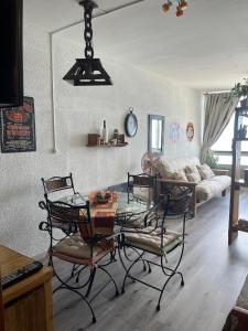 a living room with a table and chairs and a couch at Playa Club in Miramar