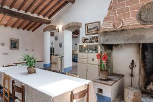 a kitchen and dining room with a table and a fireplace at La Casa di Colle in Dicomano