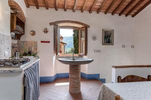 a kitchen with a sink in the middle of a room at La Casa di Colle in Dicomano +36 photos