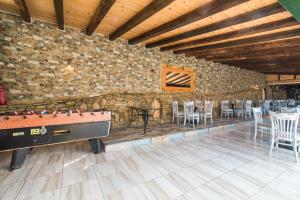 a room with a pool table and tables and chairs at Mirage Arillas Studio Type A3 in Arillas