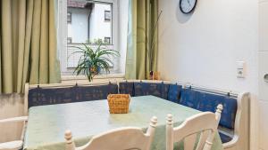 a table and chairs in a room with a window at Ferienwohnung Haas in Bräunlingen