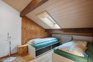 a room with two beds in a attic at Ferienwohnung Thelen in Wallbach