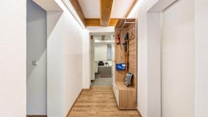 a hallway with white walls and a wooden door at Ferienwohnung Haas in Bräunlingen