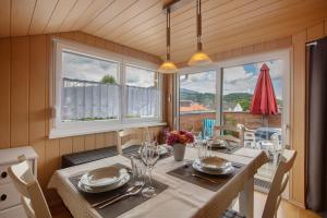 a dining room with a table and some windows at Ferienwohnung Thelen in Wallbach