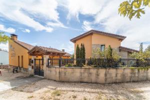 a house with a fence in front of it at La Dehesa de Santa Ursula in Espeja de San Marcelino