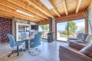 a living room with a couch and a table and chairs at Maison Les Pieds Dans L'eau in Le Verdon-sur-Mer +20 photos