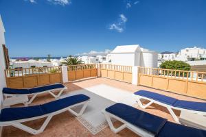 a balcony with lounge chairs and a view of the ocean at Villa Lea in Puerto del Carmen