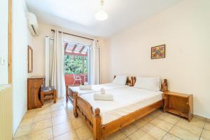 a bedroom with a bed and a window at Arianna apartment 17 in Paleokastritsa