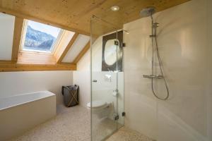 a bathroom with a shower and a toilet and a window at Maisonettewohnung am Wössener See in Unterwössen +24 photos