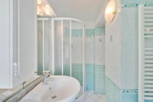 a bathroom with a sink and a mirror at Appartamento Ramerino in Pomonte +16 photos