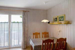 a dining room with a table and chairs and a window at Möve Aba Bungalow 60 in Rerik