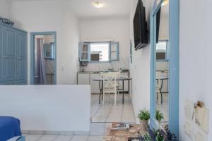 a living room with a table and a tv at Pico Bello Patmos 18 in Patmos