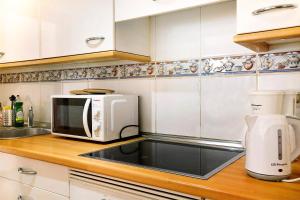 a kitchen with a microwave and a coffee maker at Ático Los Seres in Los Cristianos