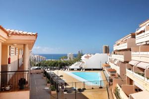 a view from the balcony of a building with a swimming pool at Ático Los Seres in Los Cristianos