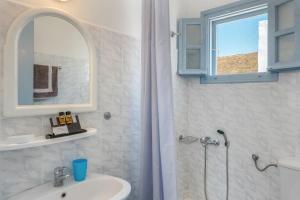 a bathroom with a shower and a sink and a mirror at Pico Bello Patmos 18 in Patmos