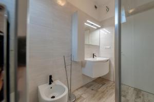 a bathroom with a urinal and a sink in it at Anghelos in Lizzanello +37 photos