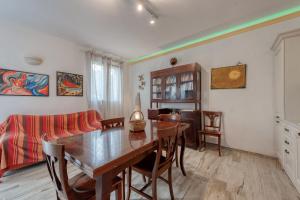 a dining room with a table and a couch at Anghelos in Lizzanello