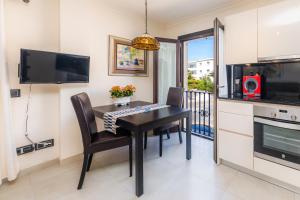 a kitchen and dining room with a table and chairs at Brillant in Cala Ratjada +12 photos