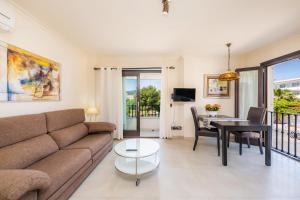 a living room with a couch and a table at Brillant in Cala Ratjada