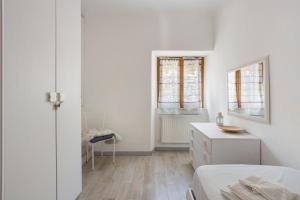 a white bedroom with a bed and a dresser and window at La ca bela in Portovenere +29 photos