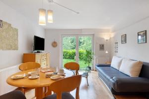 a living room with a table and a couch at Haus Marion in Todtnau