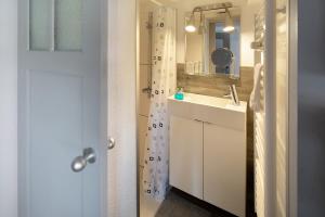 a white bathroom with a sink and a mirror at Ferienwohnung Omi Anni in Schlitz +28 photos