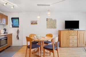 a kitchen with a table and chairs and a tv at Haus Marion in Todtnau