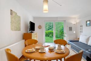 a living room with a table and a couch at Haus Marion in Todtnau