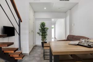 a living room with a table and a couch at Mariola in Novo Sancti Petri