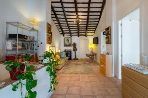 a hallway with a living room with plants at Preciosa Casa el Pedroso in El Pedroso