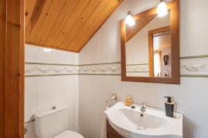 a bathroom with a toilet and a sink and a mirror at Hospitalillo in Sant Corneli de Cercs  +27 photos
