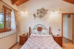 a bedroom with a bed and two night stands at Hospitalillo in Sant Corneli de Cercs 
