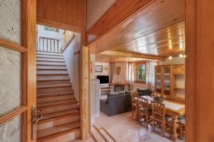 a living room with a staircase and a dining room at Hospitalillo in Sant Corneli de Cercs 
