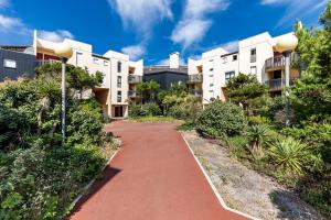 a pathway in front of an apartment building at Studio Cosy face à l'océan in Lacanau