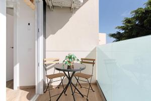 ein kleiner Tisch und Stühle auf einem Balkon in der Unterkunft Flamboyan 2 in Telde