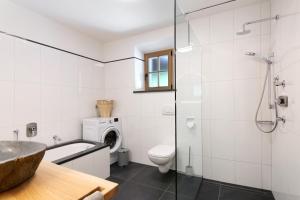a bathroom with a tub and a toilet and a sink at Bertollhof Weingenuss in Silandro +32 photos