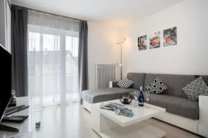 a living room with a couch and a table at Haus Bernhardt in Langenargen