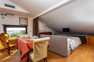 a living room with a table and a couch at The Amphora Lodging in Furci Siculo