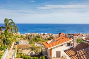 a view of a city and the ocean at The Amphora Lodging in Furci Siculo