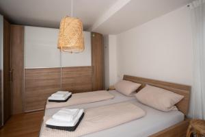 a bedroom with two beds with towels on them at Lo Ferienwohnung in Friedrichshafen