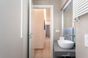 a bathroom with a white bowl sink on a counter at La Domus Firenze in Florence +37 photos