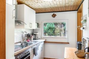 a kitchen with a sink and a window at Ferienhaus Strandfloh in Wangerooge