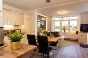 a kitchen and dining room with a table and chairs at Villa Marin Wohnung 1 in Zinnowitz