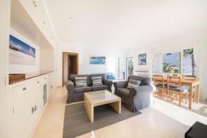 a living room with two couches and a table at Ponent in Port de Soller