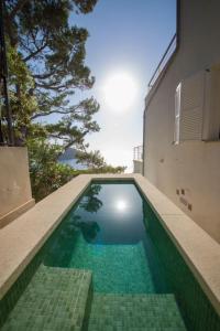 a swimming pool on the side of a house at Ponent in Port de Soller