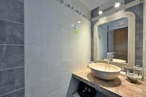 a bathroom with a sink and a mirror at Les Hélianthèmes in Guchen +57 photos